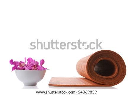 yoga mat and orchid in bowl