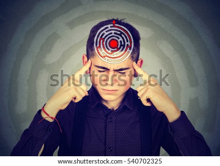 Problem solution concept. Young stressed man solving puzzle isolated on gray background Royalty-Free Stock Photo #540702325