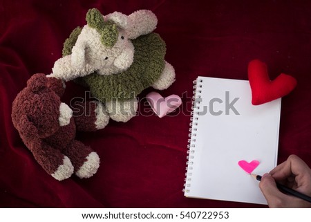 Bear holding and heart shaped  on red background