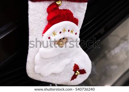 socks with a picture of Santa Claus on the fireplace for gifts