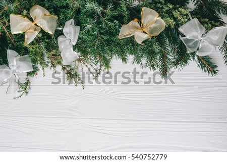 Christmas white and yellow decorations and presents on a white wooden background