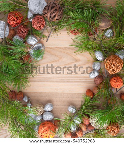 Christmas wreath on wooden background in a frame