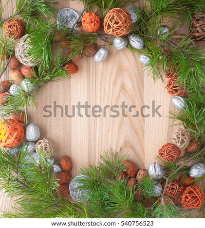 Christmas wreath on wooden background in a frame