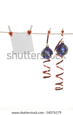 White blank and Christmas balls hanging from a rope. Isolated on white background