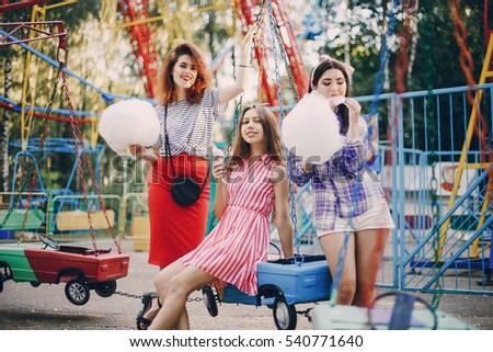 three stylish girls walking city and playground