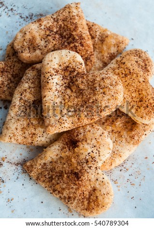 Valentines day heart shaped cookies with sugar and cinnamon - festive dessert idea for holidays, closeup, top view