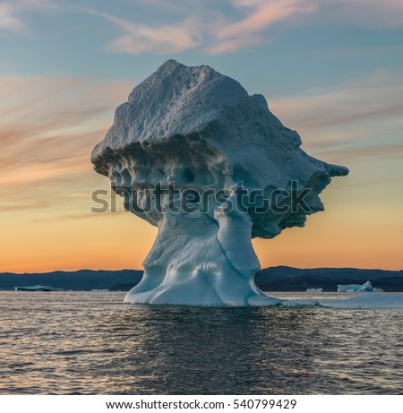 Icebergs of different forms in the Disco Bay, Greenland. Their source is by the Jakobshavn glacier. This is a consequence of the phenomenon and catastrophic thawing of ice. Ilulissat on background 