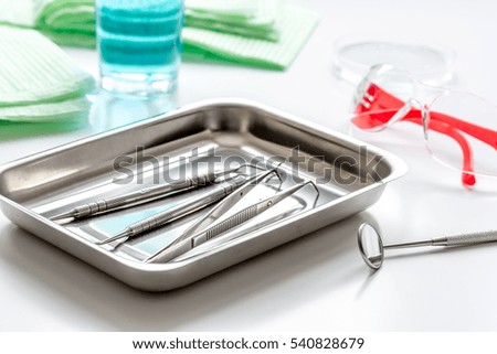 dentists tools in cabinet on white desktop