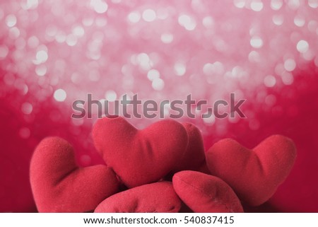 Abstract picture group of red heart pillow on bokeh background,  for Christmas, happy New Year celebration, valentine day, warm feeling by sending the messages to someone the best wishes, and love