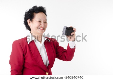 Senior woman selfie with camera over white background