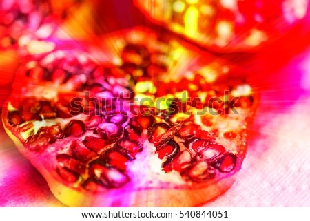 Antioxidant exotic pomegranate fruit with seeds. Close-up of red sliced punica granatum fruit for healthy snack or diet, for food business concept cooking blog receipes. Image with color filter effect