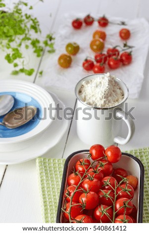 Healthy food & drink Italian healthy lifestyle. Mediterranean fresh vegetables spices &  herbs. Red cherry tomatoes flour parsley herb on the kitchen table. Top view White background