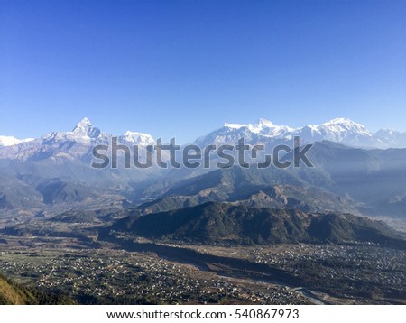 Soft image contain noise and grain the landscape of Annapurna Range during sunrise and foggy from Sarangkot, Pokhara, Nepal.