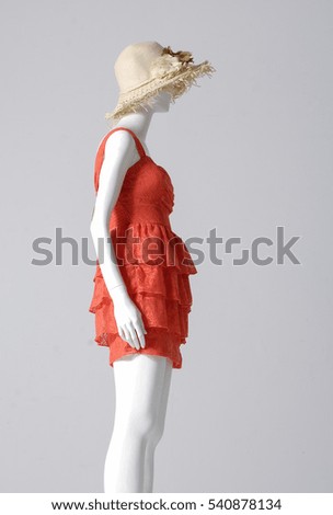 Side view mannequin in female sundress with ,hat â??gray background