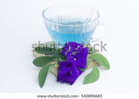 Butterfly pea juice and flowers on a white background.