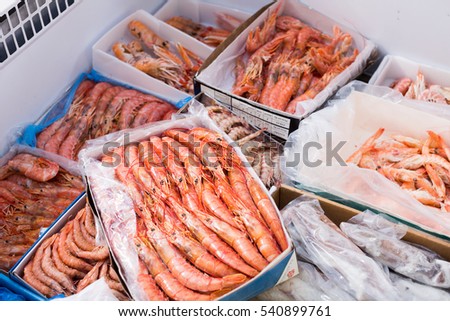 Assortment of cooled seefoods in show-case at fish market
