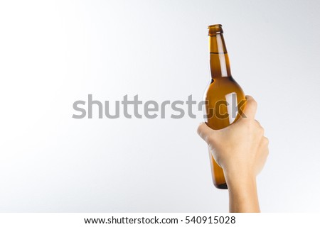 Hand holding a beer bottle without label isolated on white background Royalty-Free Stock Photo #540915028