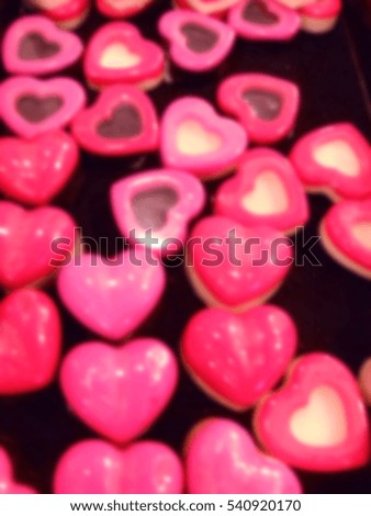 Blurred heart chocolates background.
