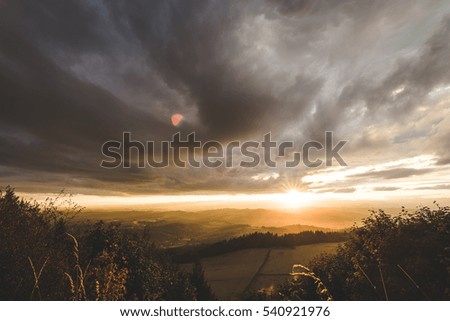Sunset with beautiful clouds over a rural Oregon countryside. Dark clouds over farm land.