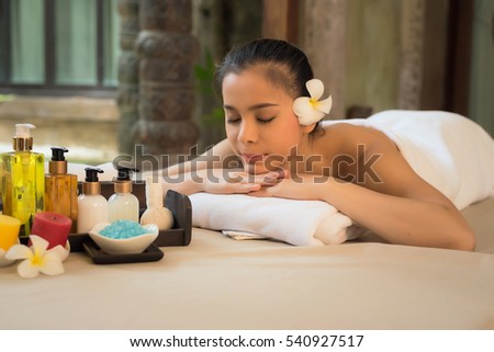 portrait of young beautiful woman in spa environment with spa treatment set