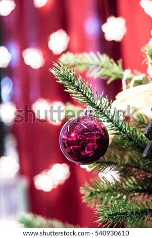 Red christmas ball and white snowflake on the xmas tree. Merry christmas card. Winter holidays. Xmas theme. Happy New Year.