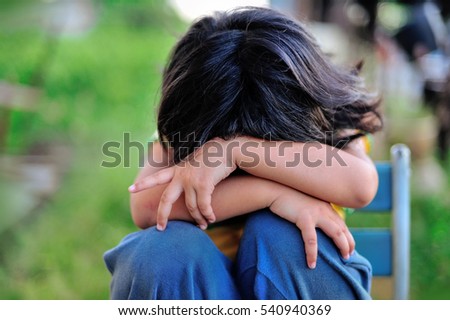 close-up portrait of a girl crying and covering her face Royalty-Free Stock Photo #540940369