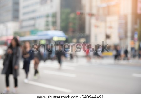 Blurred background of busy city street people on zebra crossing