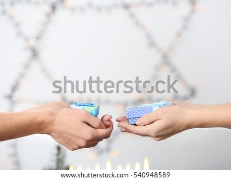 People giving presents for Hanukkah to each other, closeup