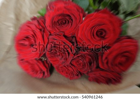 Arrangment of red blooming roses. Romantic bouquet with withering flowers for birthday gift, mothers day, valentines love present, wedding and bridal decoration. Image with motion blur filter effect.
