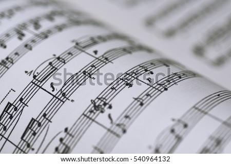 Abstract view of music. Book with notes. Royalty-Free Stock Photo #540964132