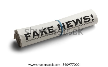 Rolled Up Newspaper with Headline of Fake News Isolated on White Background. Royalty-Free Stock Photo #540977002