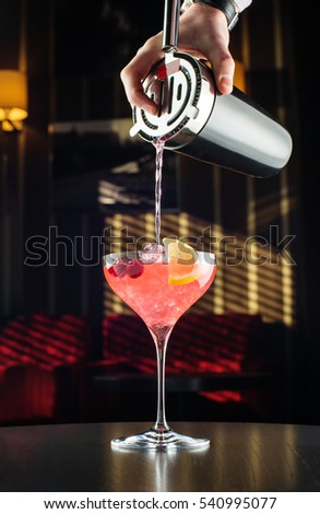 Barman at work, preparing cocktails. pouring margarita to cocktail glass. concept about service and beverages. Royalty-Free Stock Photo #540995077