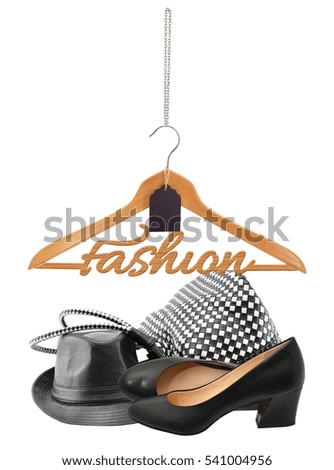 Fashion Wood Hanger with Price Tag hanging over Women's Fashion Hat, Handbag and High Heel shoes isolated on white background