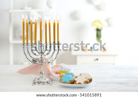 Beautiful composition for Hanukkah on wooden table against blurred background