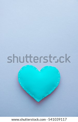 Pretty, delicate, beautiful, attractive handmade foamiran material toy in the form of heart of Valentine's day. Background as a design element. Postcards, congratulations. Close-up. Flat Lay.