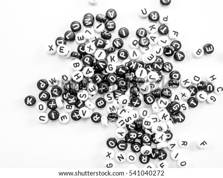     heap of round letters black and white spread on white background