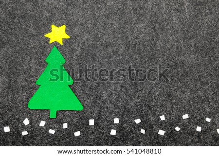 Christmas tree on grey background.  Felt Christmas ornaments with copy space