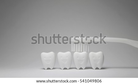 White Toothbrush on Tooth model in happy emotion, if brush the teeth, teeth will good healthy