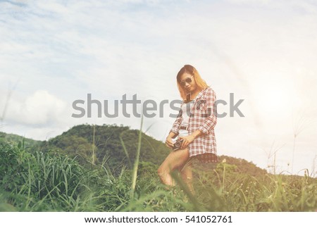 Young Hipster Woman with retro camera taking shot outdoor landscape ,Lifestyle mountain nature on background.