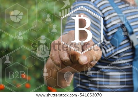 Farmer businessman, choosing bitcoins clicks on the touch screen in the web network. The latest technology work with Finance in the networks. The concept of distribution of bitcoins .  
