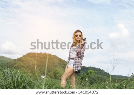 Young Hipster Woman with retro camera taking shot outdoor landscape ,Lifestyle mountain nature on background.