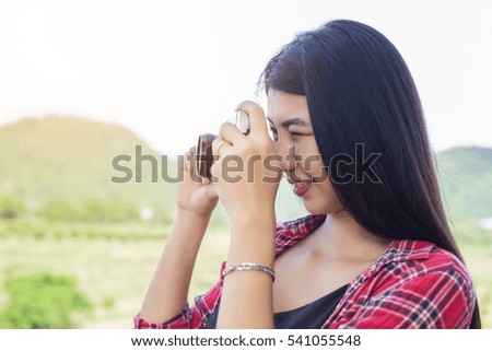 Young hipster woman photographer holding a vintage camera. 