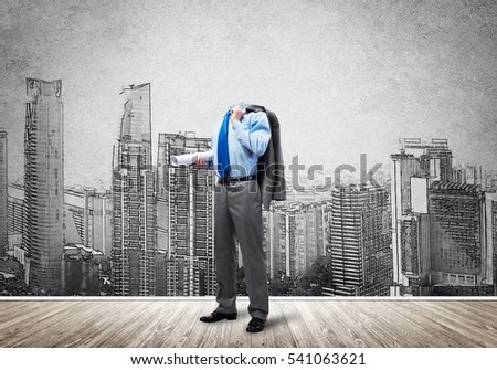 Headless engineer man with papers in hand against construction background