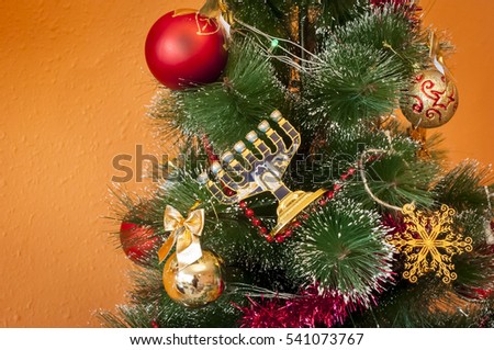 Jewish menorah on a decorated Christmas (New Year) tree. In December 2016 Jewish holiday Hanukkah coincides with Christmas and New Year. 