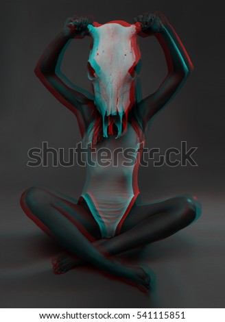 photo model with Slavic appearance who is sitting on the floor cross-legged and holding his face in the background skull of a bull, made in the style of three-dimensional graphics