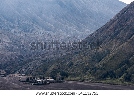 view of Mount Bromo under cloudy sky with the sand sea