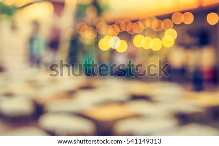 abstract blur image of food stall at day festival for background usage. (vintage tone)