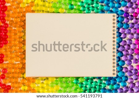 Glass bubbles and notebook / Colorful polka dots sweet jell candy isolated on seamless background / celebration book empty page for postcard / rainbow gradient