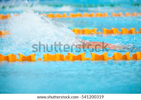 Blurry background of splash drop water on swimming race.