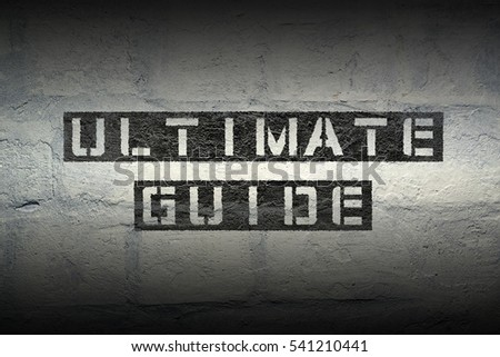ultimate guide stencil print on the grunge white brick wall 